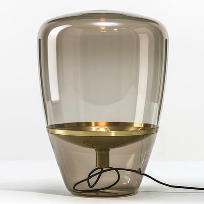 minimalist glass bedside lamp with warm glow in modern bedroom setting