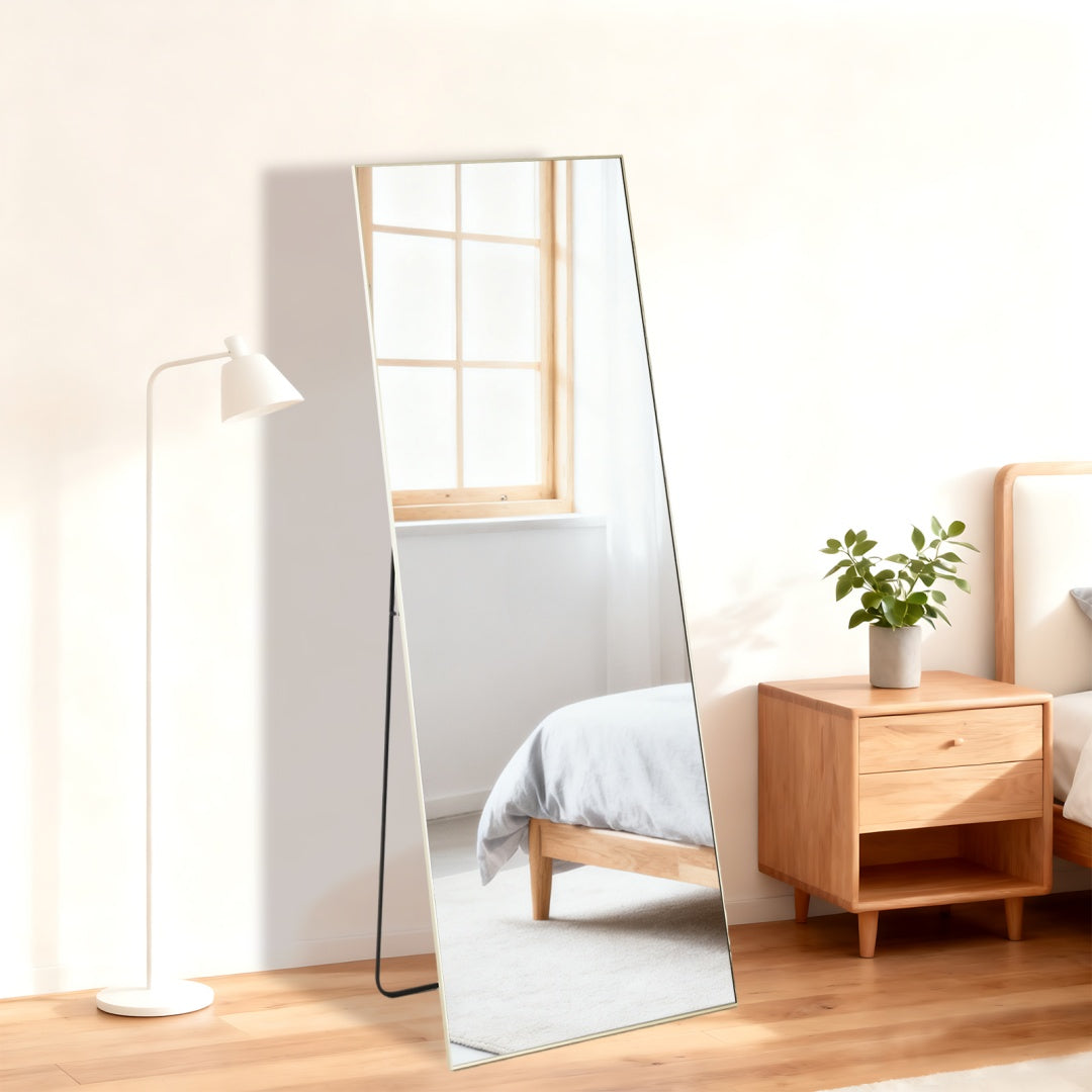 standing mirror placed in entryway with neutral decor