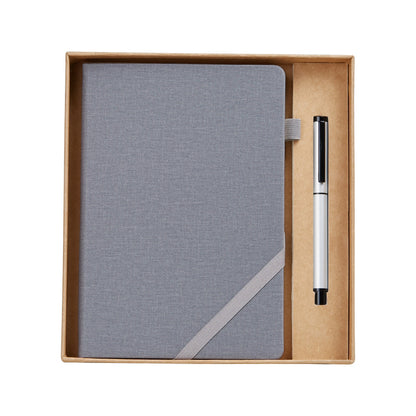 modern desk setup featuring notebook set and pen