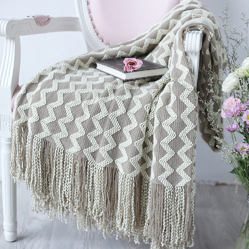 cozy throw blanket styled on bed with minimalist decor