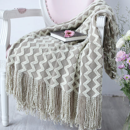 cozy throw blanket styled on bed with minimalist decor