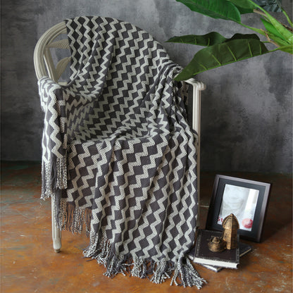 soft knit throw blanket with geometric pattern on modern sofa