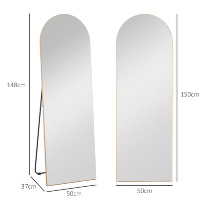 gold curved mirror leaning against wall modern bedroom