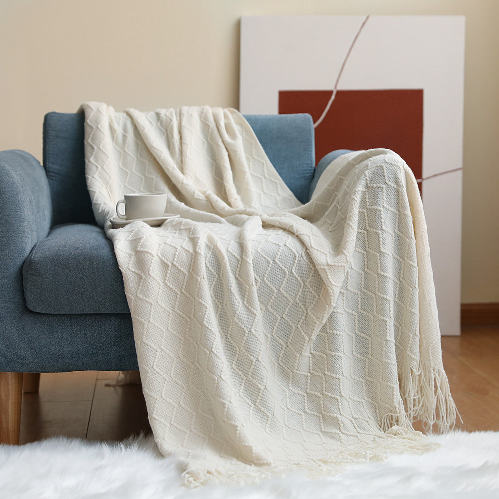 beige throw blanket cozy living room styling warm lighting