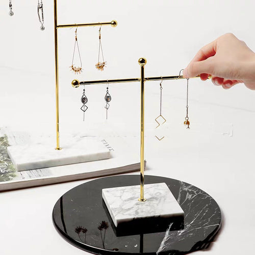 gold jewelry stand marble base vanity styling neutral bedroom