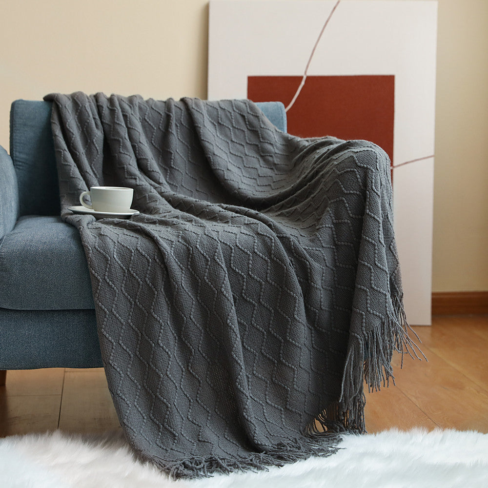 nordic style blanket draped over sofa neutral aesthetic