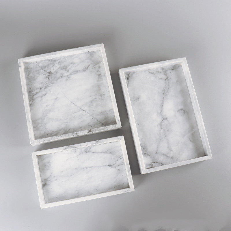 minimalist stone style tray on coffee table with decorative accents