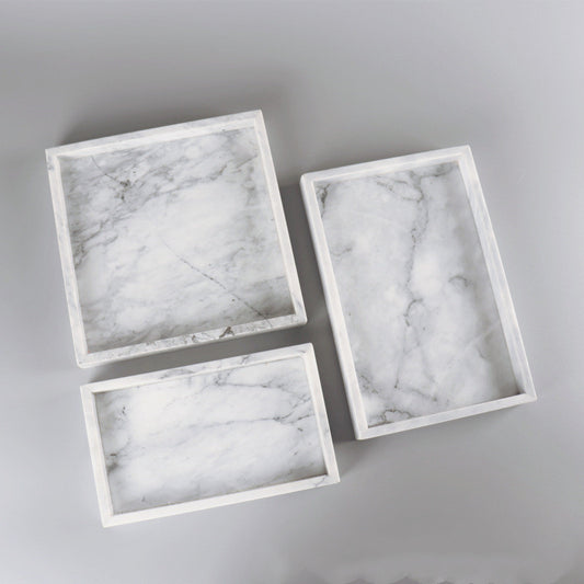 minimalist stone style tray on coffee table with decorative accents